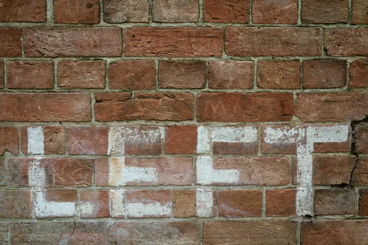 An image of a brick wall with the word LEFT painted in white.