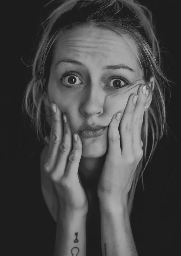 A black and white portrait image of a confused woman