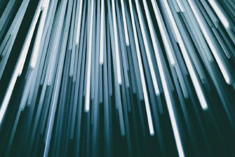 An abstract background of blue and white vertical lines. Photo by Christopher Burns on Unsplash